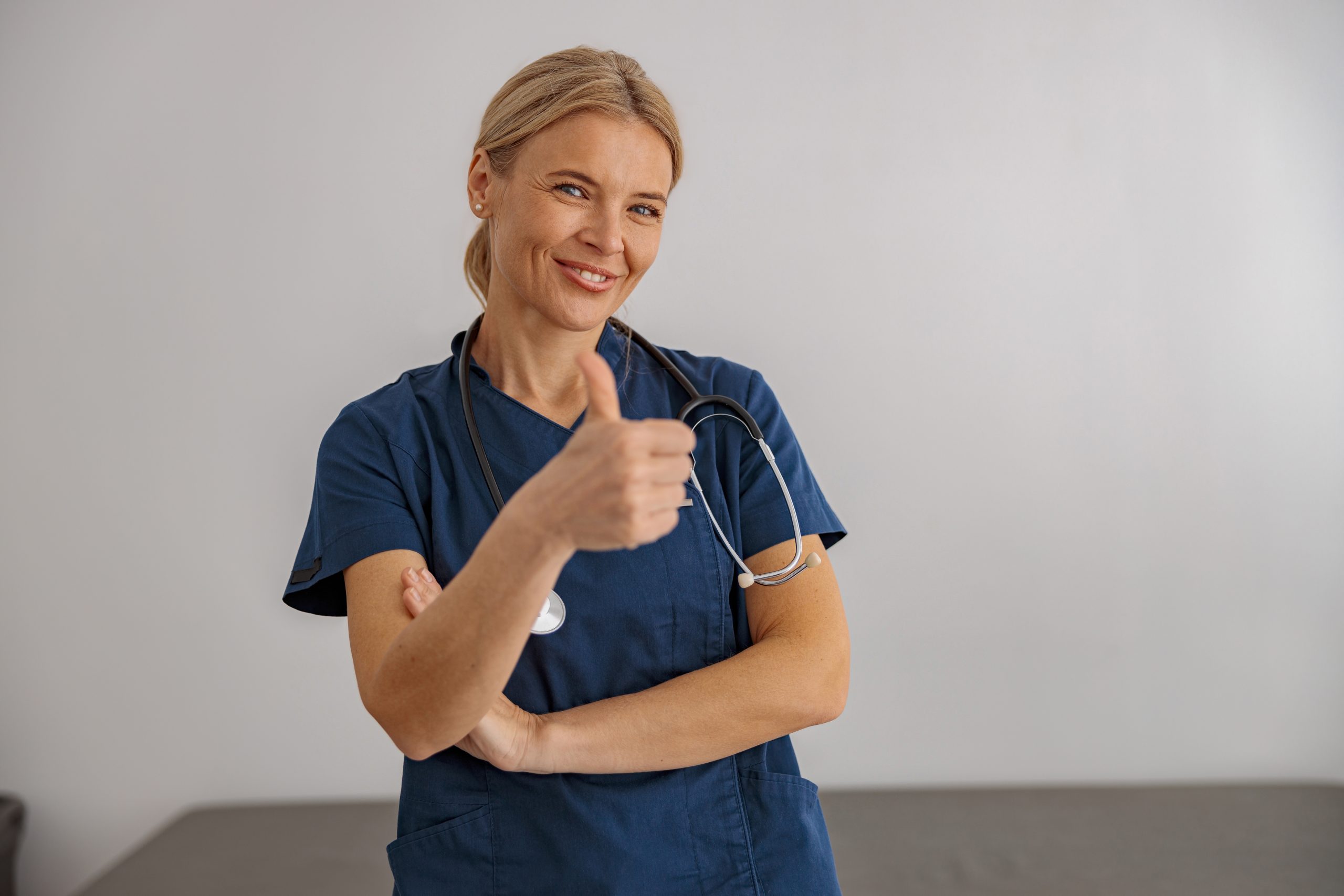 Smiling,Woman,Doctor,With,Stethoscope,On,Workplace,In,Hospital,Looking